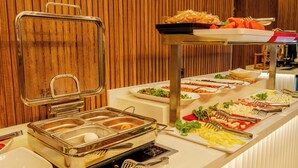 A buffet setup with multiple food stations and utensils. - Frt Airlines Hotel - Istanbul Airport (Arnavutköy)