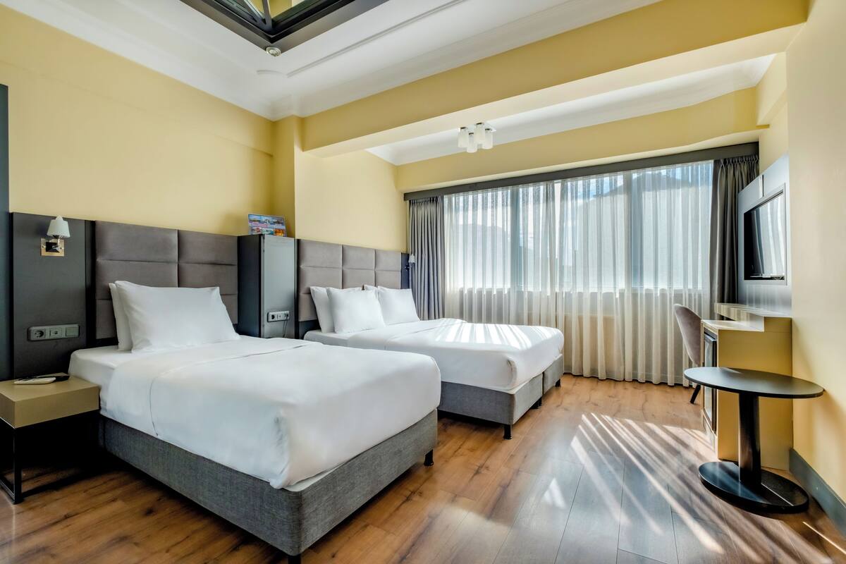 Family Room | Premium bedding, laptop workspace, blackout curtains, soundproofing