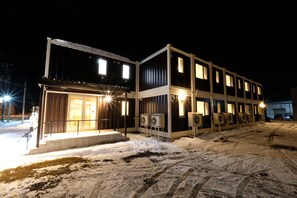 A two-story building with multiple windows and a snow-covered ground. - Cozy Inn Otaru (Otaru)