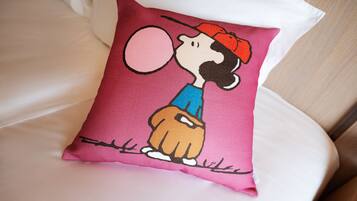 A pillow with a cartoon character on it.