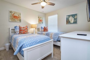 A bedroom with two beds, a ceiling fan, and artwork on the walls. - Spacious Storey Lake Home: Walk to Resort, BBQ, Game Room & Free WiFi! (Kissimmee)