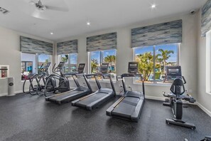 A gym with treadmills, elliptical machines, and a rowing machine.