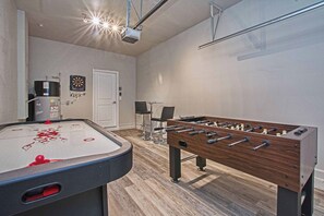 A room with a foosball table, a pool table, and a dartboard. - Spacious Storey Lake Home: Walk to Resort, BBQ, Game Room & Free WiFi! (Kissimmee)
