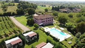 A large building with a swimming pool, surrounded by lush greenery and fields. - Agriturismo Ca' Vecia (Sona)