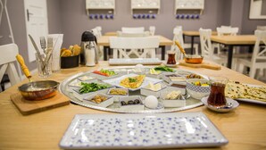 A dining table set with various dishes, utensils, and a decorative tray.