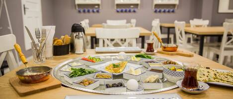 A dining table set with various dishes, utensils, and a decorative tray.