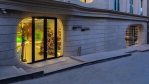 Un edificio con grandes ventanales y una entrada de cristal.