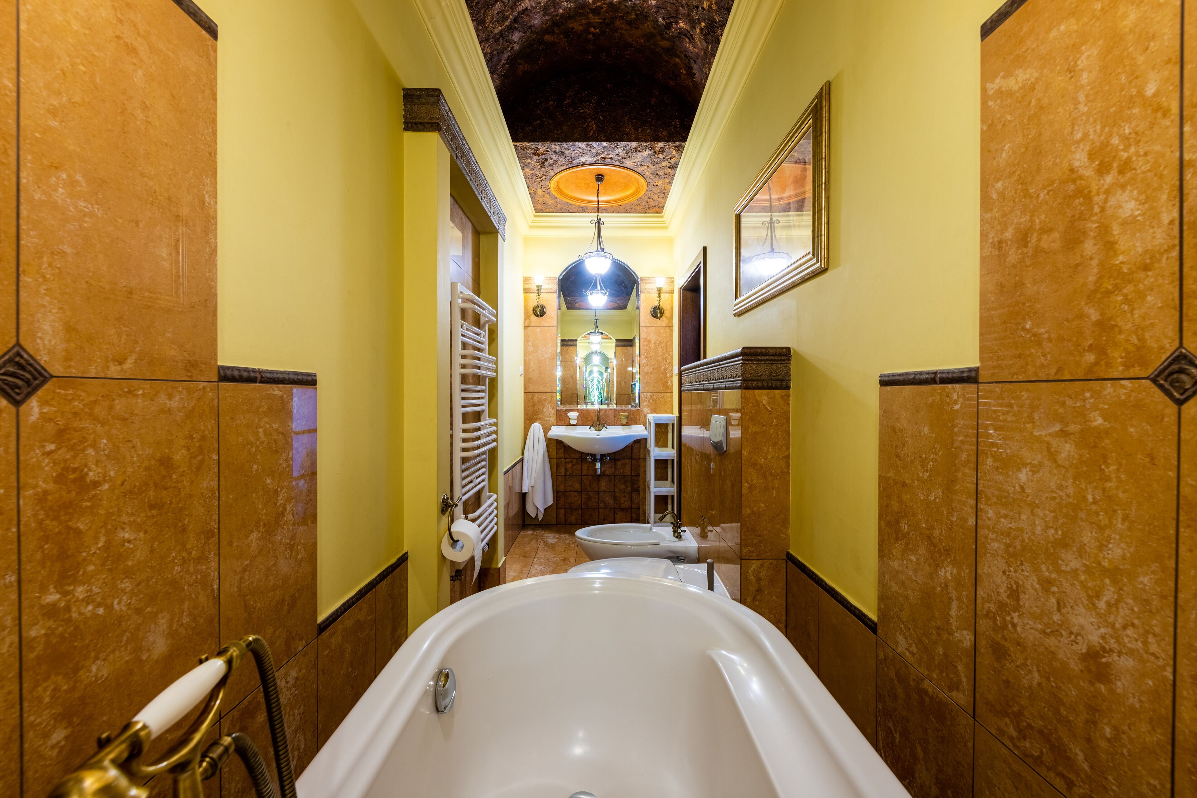 A luxurious bathroom with a large bathtub, a sink, and a mirror.