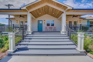 A two-story building with a wooden porch, a blue door, and a number 14 sign. - 5BR Mnt Viewsdowntown Luxuryfirepit & RV Parking (Colorado Springs)
