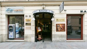 A restaurant entrance with a sign reading "Leonardo Restaurant" and a visible ATM on the left. - Sodispar Szpitalna Old Town Apartments (Kraków)