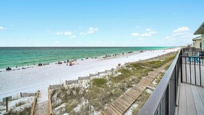 A beach with a wooden boardwalk, a sandy beach, and a clear blue sky. - Into the Blue - Oceanfront Condo with Beach Access & Gulf Views (Miramar Beach)
