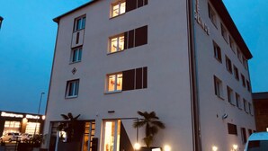 A multi-story hotel with a flat facade, large windows, and a visible entrance with a glass door.