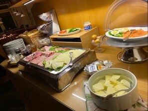 A buffet with various food items including meats, cheeses, and a bowl of soup. - Hotel Seebach (Grossenseebach)