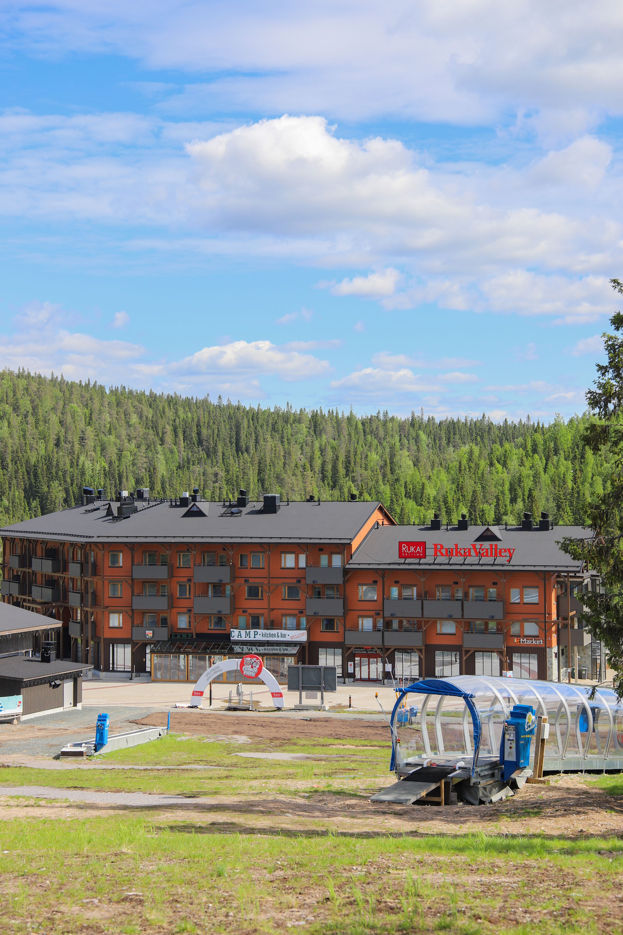 A building with a sign reading "Ruka Valley" and a large tent-like structure in front.