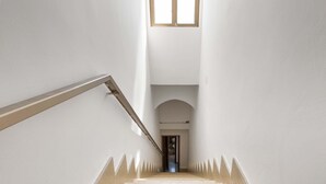 Una escalera con barandilla que lleva a un arco en la parte superior.