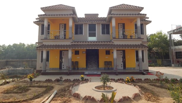 A two-story building with a symmetrical facade, balconies, and a central entrance. - Asian Grand Villa (Bolpur)