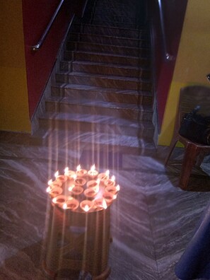 A staircase with a circular arrangement of candles at the bottom.