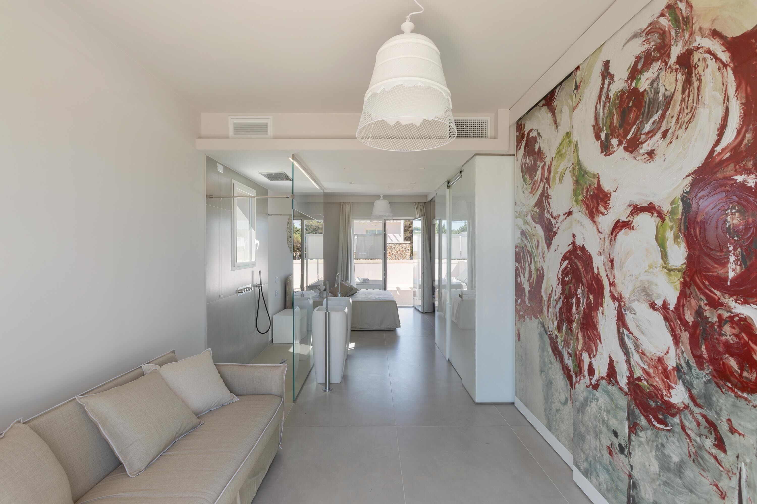 A modern interior with a neutral color scheme, a large abstract painting, and a minimalist design.