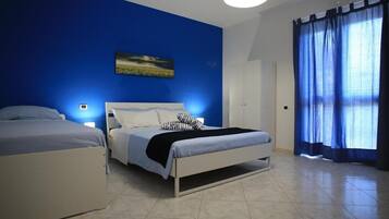 Deluxe Triple Room | Hypo-allergenic bedding, down comforters, in-room safe, blackout drapes