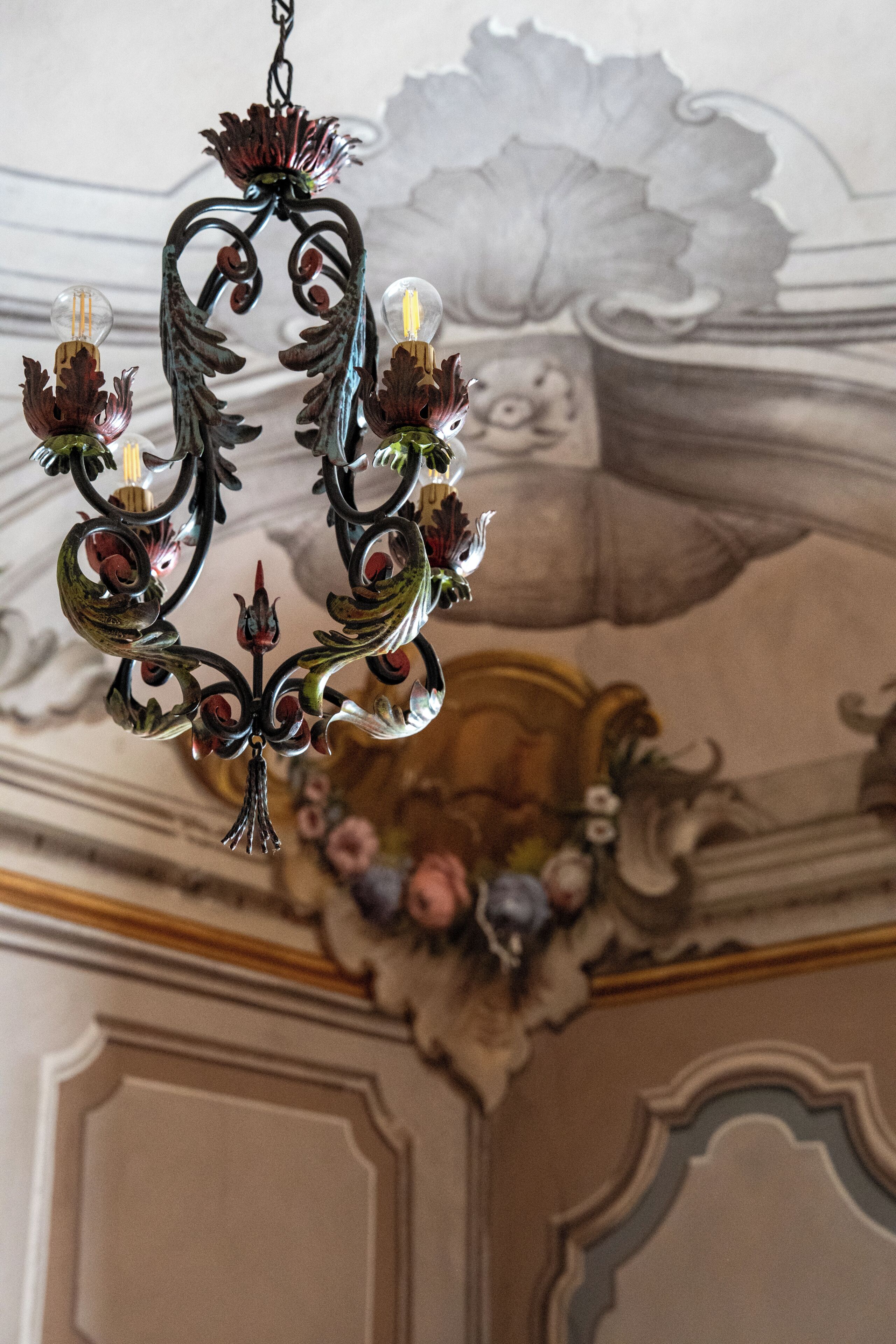 A chandelier with multiple bulbs and ornate metalwork.
