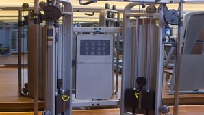 A gym with a variety of exercise machines, including a cable machine and a squat rack. - GreenTree Eastern Handan Daming County Bus Station (Handan)
