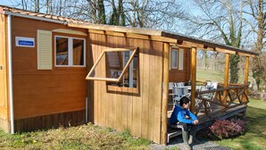 A wooden cabin with a sign reading "Clevacances." - Camping La Chevauchée (Bussière-Dunoise)