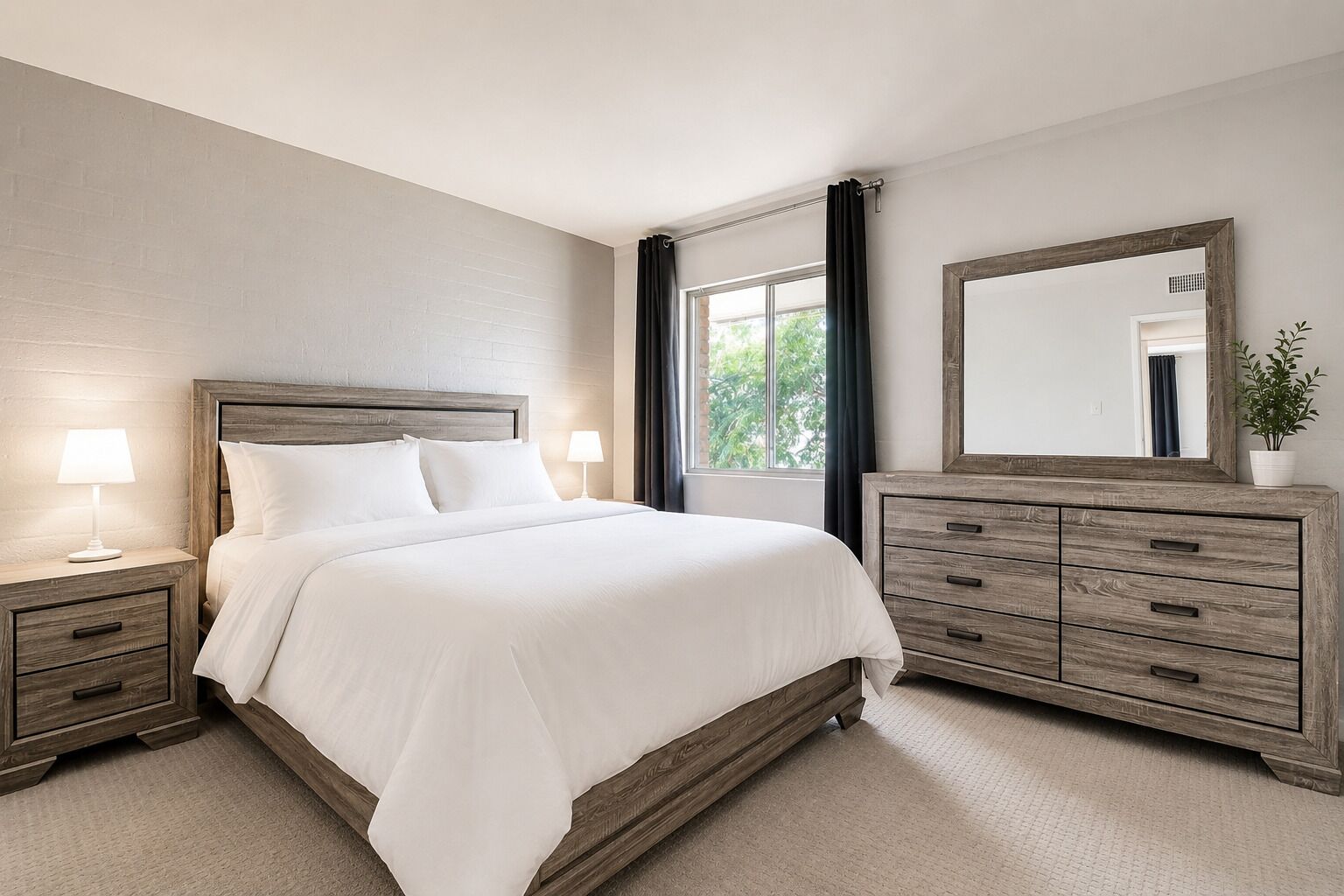 A bedroom with a bed, bedside tables, a dresser, a mirror, and a window with curtains.