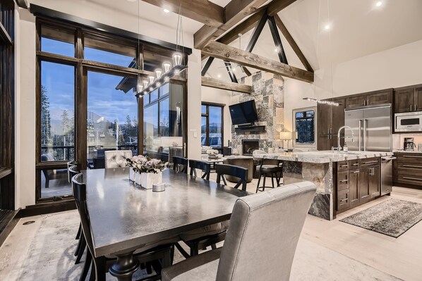 A modern kitchen with a large island, built-in appliances, and a stone accent wall. - Closest to Gondola | Shock Hill Majestic | Views! (Breckenridge)