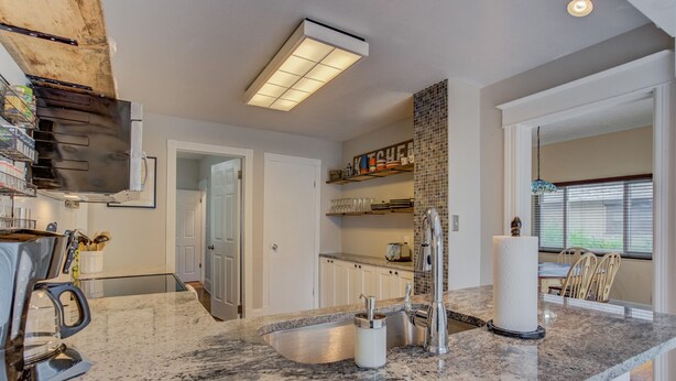 A modern kitchen with granite countertops, stainless steel appliances, and a built-in oven. - 3BR Hot-tub & Dog-friendly Old Colorado City!! (Colorado Springs)