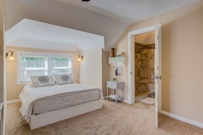 A bedroom with a bed, a nightstand, a window with blinds, a wall-mounted shelf, and a shower area. - 4BD Luxuryclose to Downtown3ba & Pet-friendly!! (Colorado Springs)