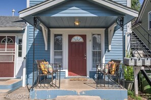 A blue house with a red door, two porch chairs, and a mailbox. - 3BR Of Downtown King Bed, Dining, Has It All! (Colorado Springs)