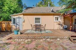 A house with a patio, a door, and a window.