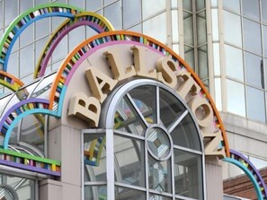 A building with a large arched entrance and the word "BALLSTON" prominently displayed above it. - National at Ballston Metro (Arlington)