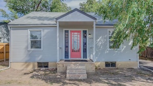 A single-story house with a red front door, a small porch, and a mailbox. - 2BR Olympic Training Center Dog-friendly (Colorado Springs)