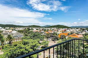 A residential area with houses, greenery, and a clear sky.