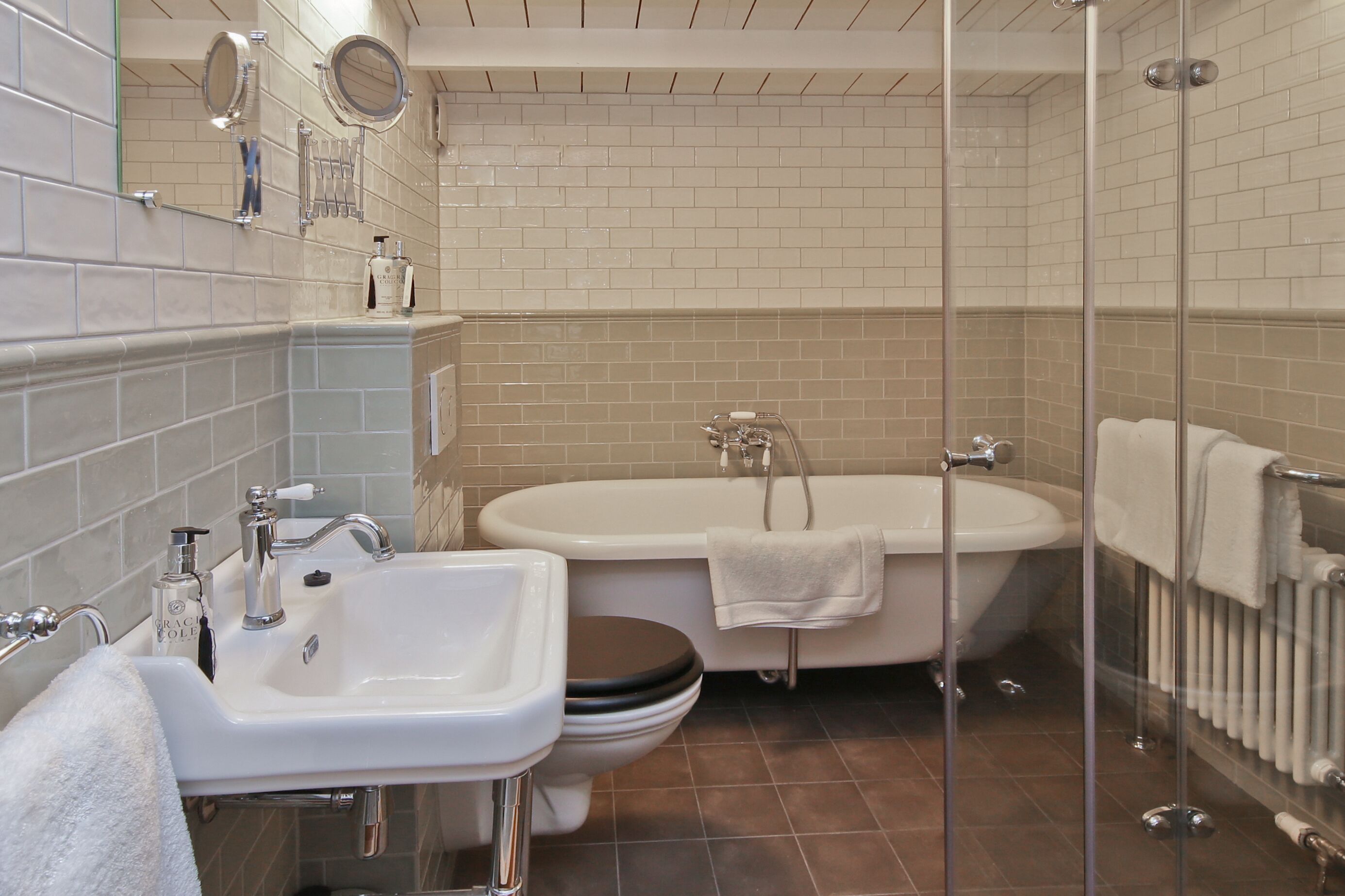 A modern bathroom with a bathtub, a sink, and a toilet.