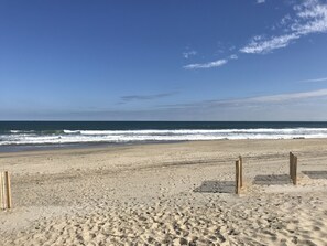 Enjoy the serene beach with its sandy shoreline and gentle ocean waves.