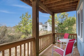 Enjoy a peaceful view from this deck overlooking a residential area with houses and trees.