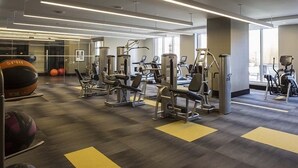 A modern gym with various exercise machines, large windows, and a clean, organized layout. - National at Reston Town Center (Reston)