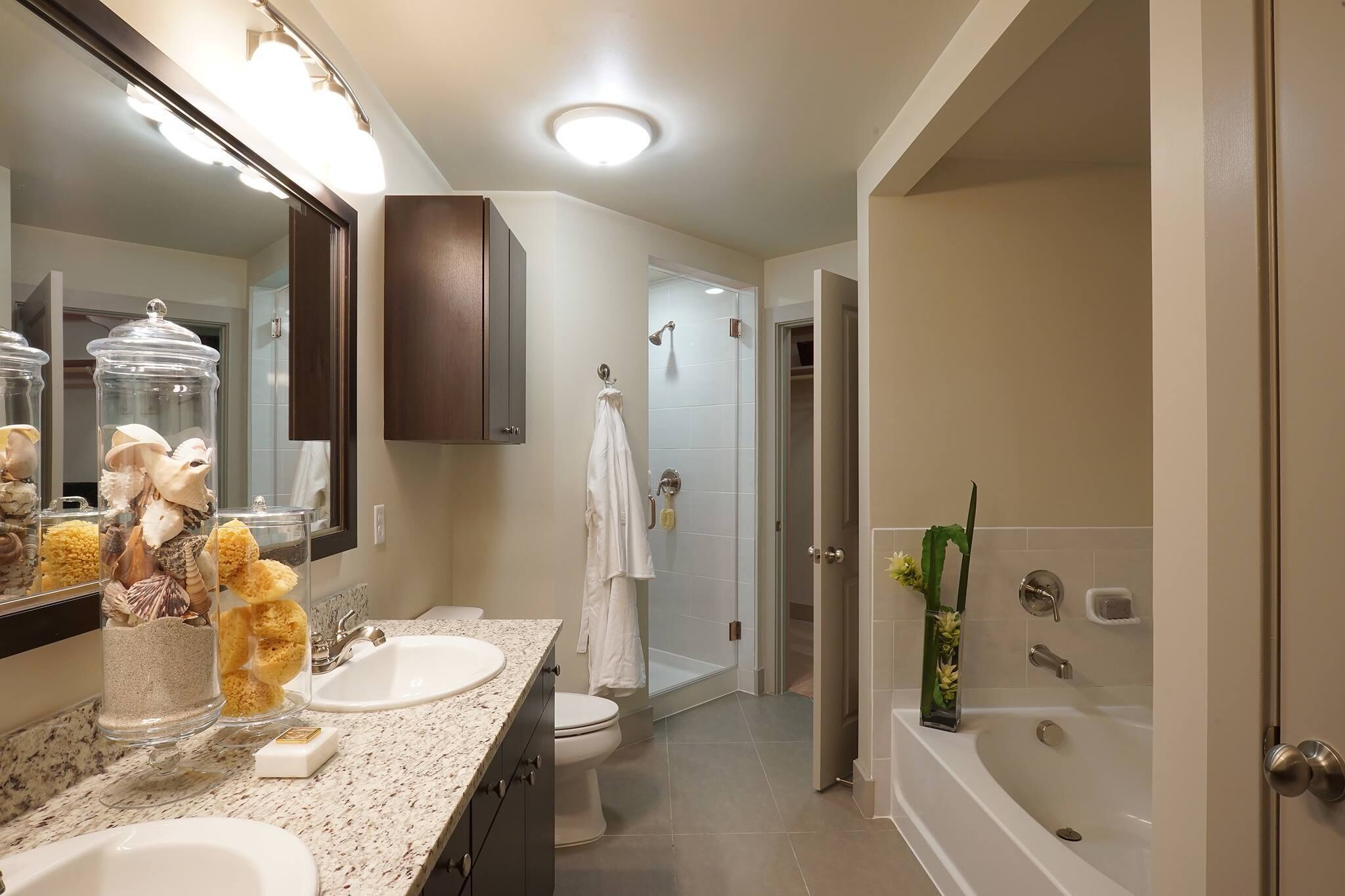 A modern bathroom with a sink, toilet, and shower area.