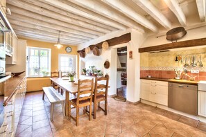 Enjoy cooking in this well-equipped kitchen with a dining table, oven, and dishwasher.