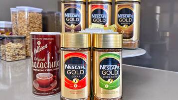 A variety of Nescafe Gold coffee products including Original, Intense, and Smooth flavors, as well as Decaf and Green Blend options.