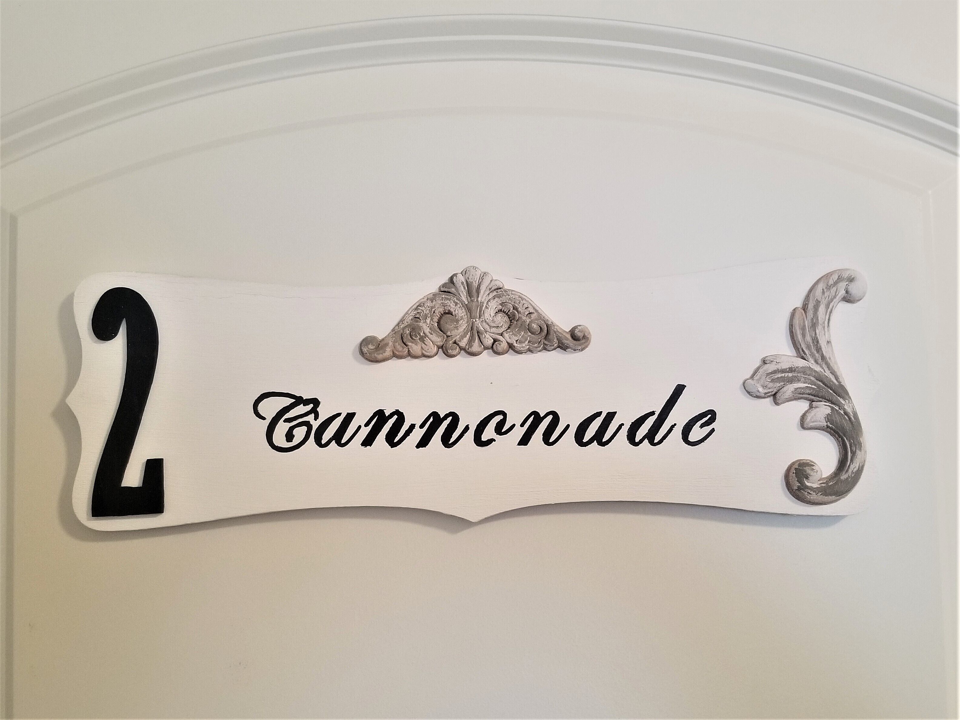 A decorative sign with the number 2 and the word "Cannonade" on it.