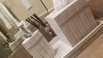 A bathroom with a mirror, a soap dispenser, and a tissue holder.