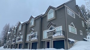 A multi-story residential building with a snow-covered roof and balconies. - Schweitzer Ski Condo, Sandpoint, Lake Pend Oreille (Sandpoint)