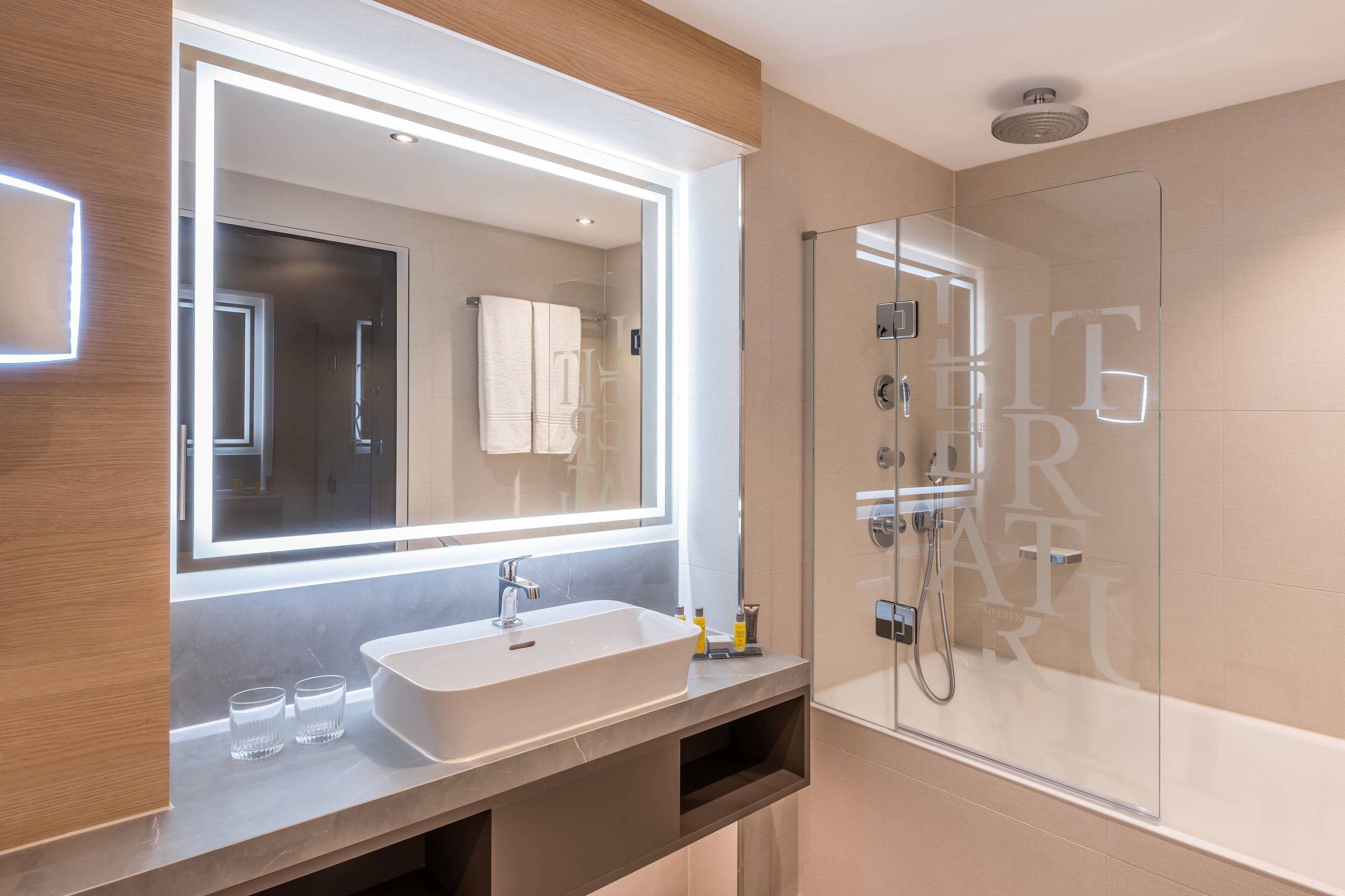 rainfall showerhead, towels, soap, shampoo