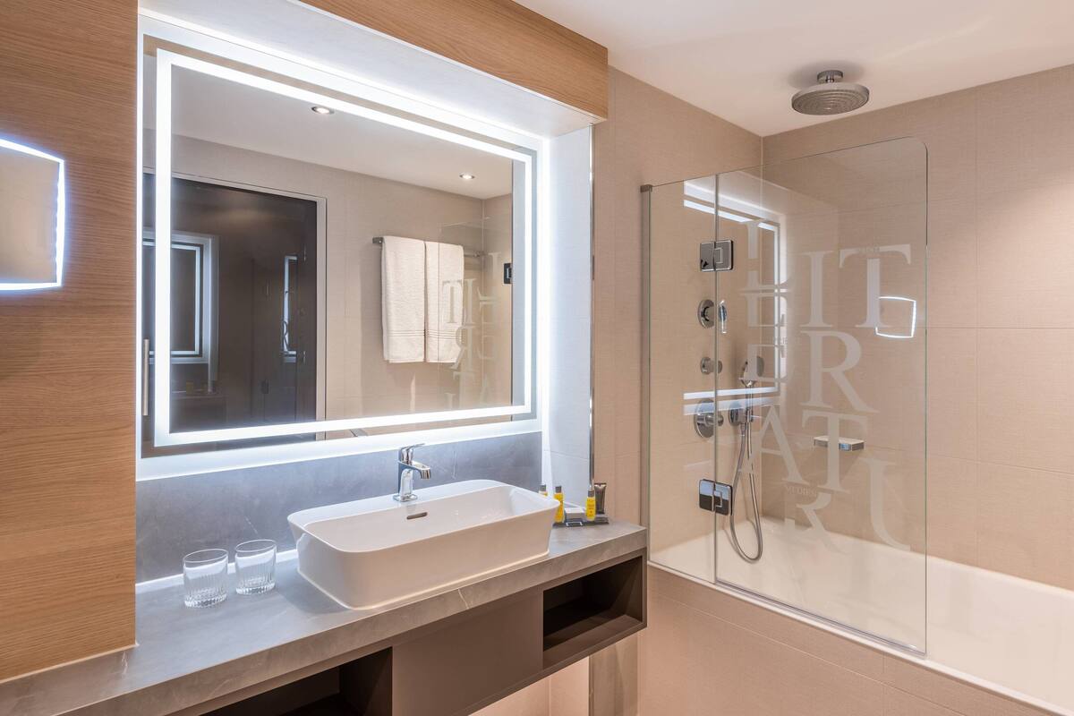 rainfall showerhead, towels, soap, shampoo