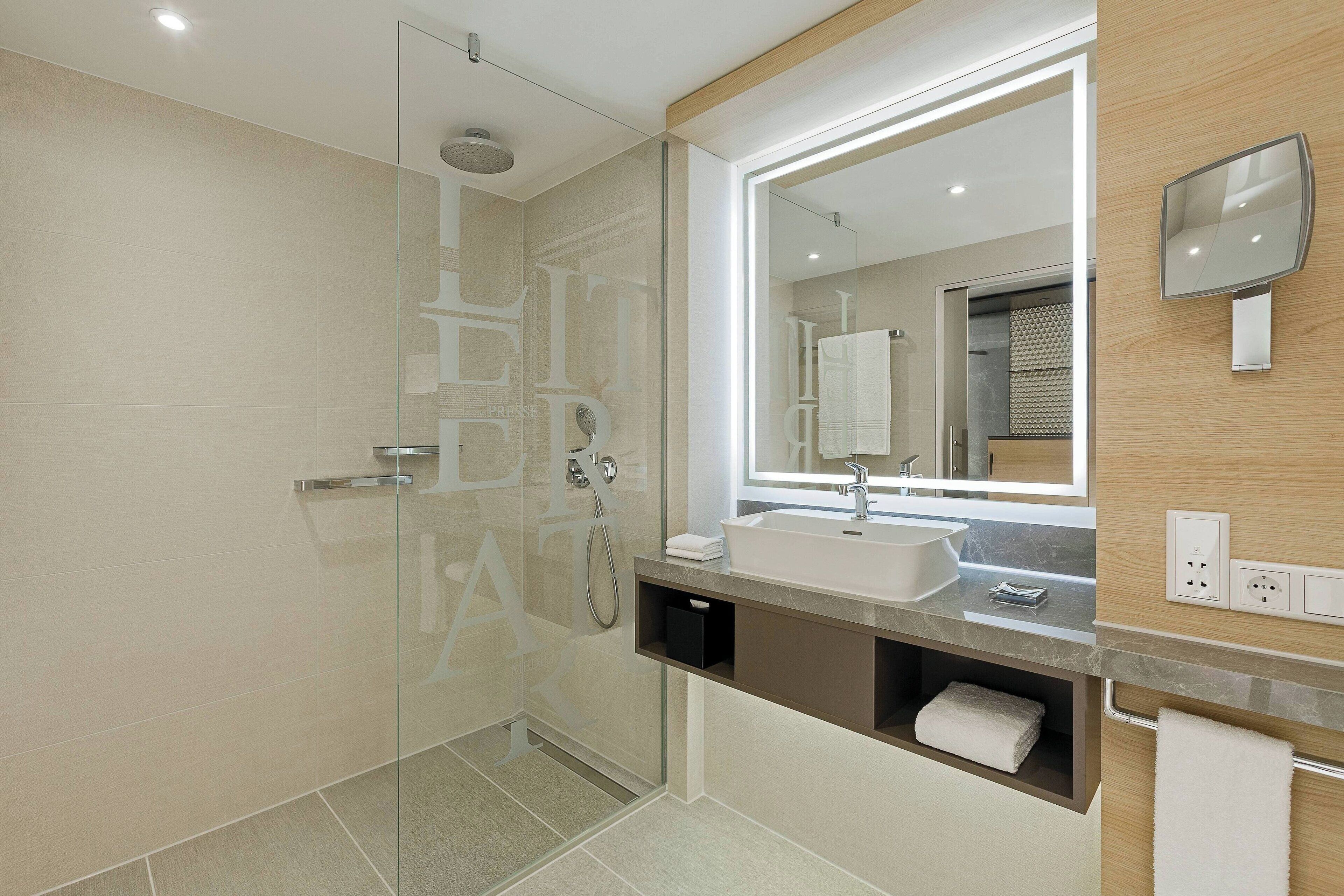 rainfall showerhead, towels, soap, shampoo