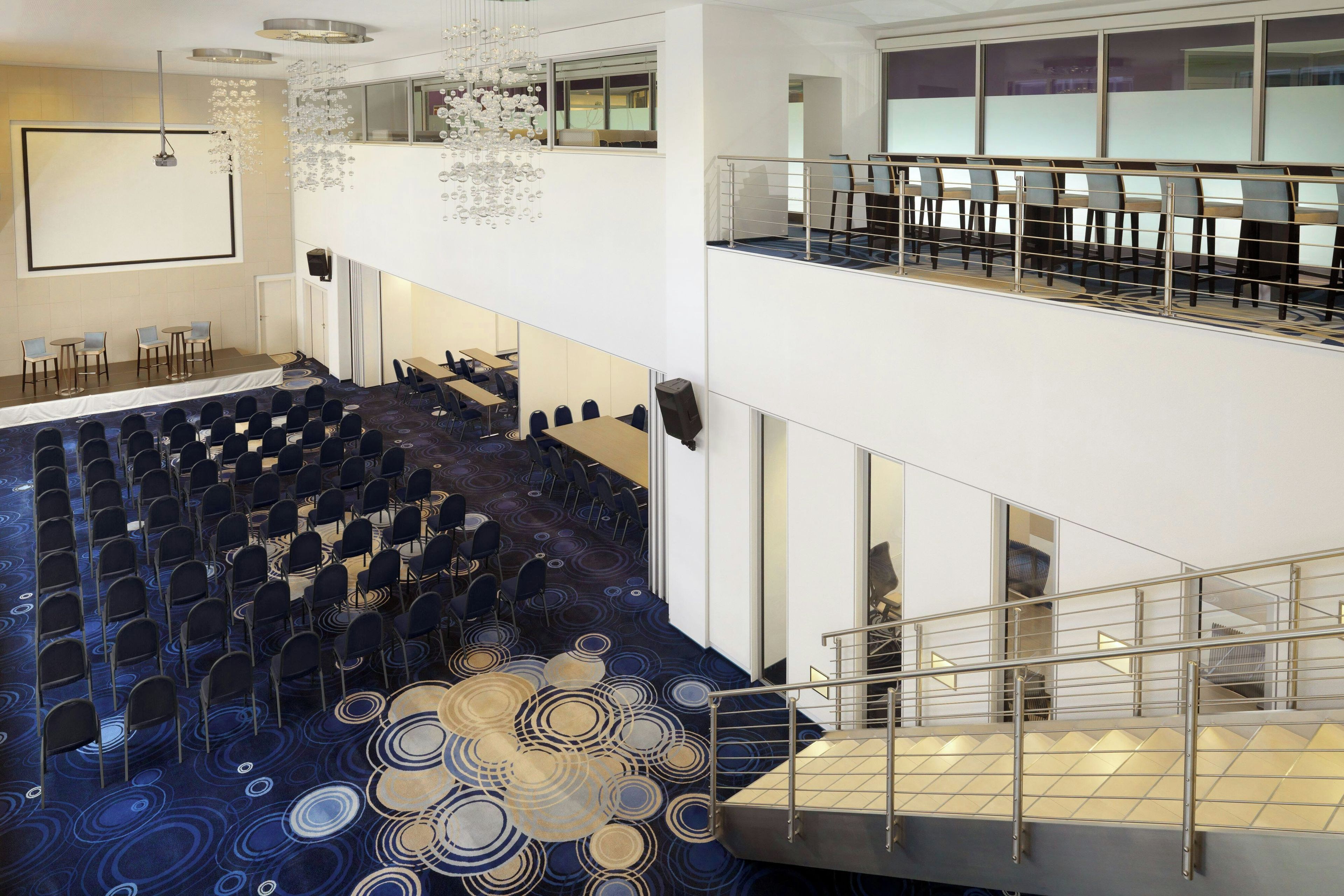 A multi-level conference room with tiered seating and a patterned carpet.