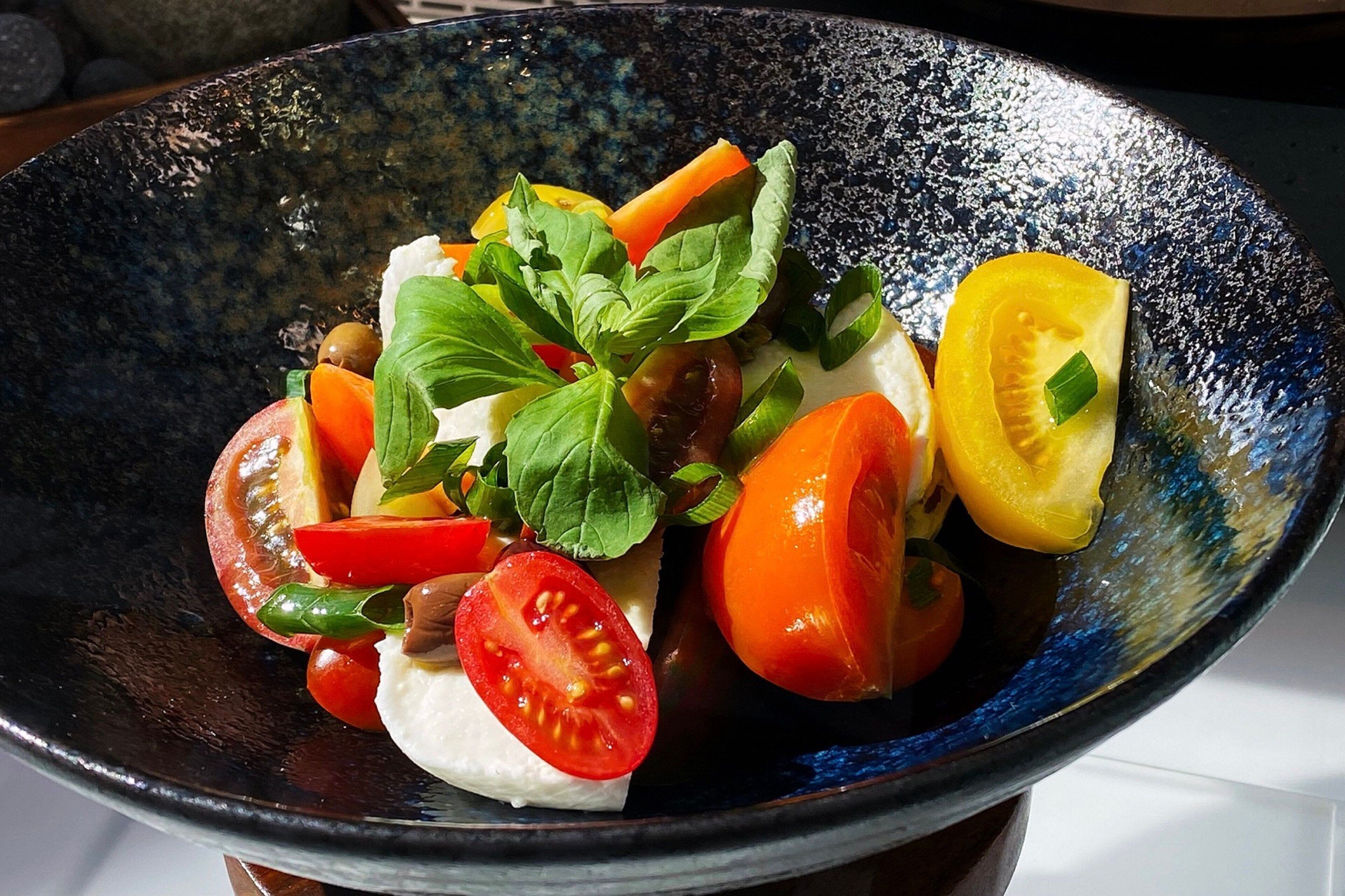 Insalata fresca con pomodori, carote e basilico.